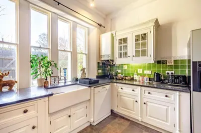 a kitchen with white cabinets and a sink at 4 Bed in Great Clifton oc-r34663 in Great Clifton