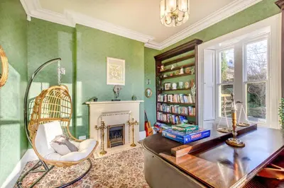a living room with green walls and a fireplace at 4 Bed in Great Clifton oc-r34663 in Great Clifton