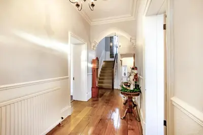 a hallway with white walls and wood floors and a staircase at 4 Bed in Great Clifton oc-r34663 in Great Clifton