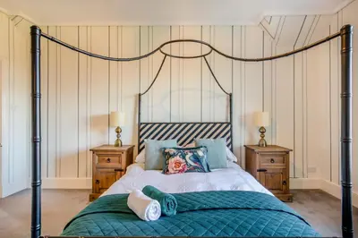 a bedroom with a bed and two night stands at 4 Bed in Great Clifton oc-r34663 in Great Clifton