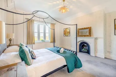 a bedroom with a bed and a fireplace at 4 Bed in Great Clifton oc-r34663 in Great Clifton