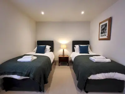a bedroom with two beds and a lamp in it at Wetherlam View Little Langdale in Little Langdale