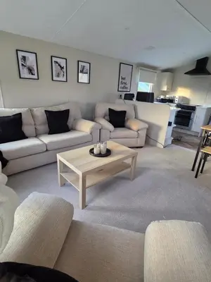 a living room with a couch and a coffee table at Noah's Luxe Retreats in Newton Stewart