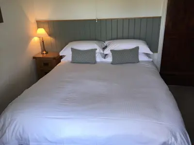 a large white bed with two pillows on it at High Snab Cottage Newlands Valley in Keswick
