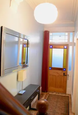 a room with a table and a door with a lamp at The old townhouse in Carlisle