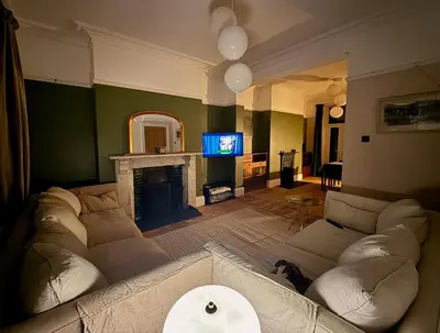 a living room with a couch and a fireplace at The old townhouse in Carlisle