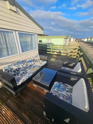 a balcony with beds and couches on a house at Number34 in Drummore