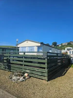 a group of sheep laying on the ground in front of a building at Number34 in Drummore