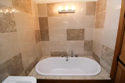 a bath tub in a bathroom with a toilet at Mindrum, Skelton a spacious and characterful house close to Penrith & Ullswater in Skelton