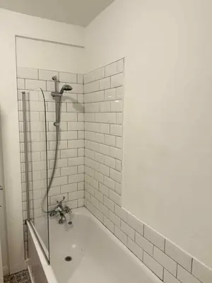 a white bathroom with a tub and a shower at Brisco Terrace-sleeps 6 in Woodend