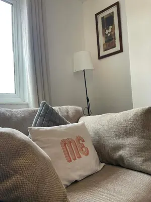 a living room with a couch with a mos pillow on it at Brisco Terrace-sleeps 6 in Woodend