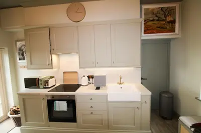 a small kitchen with a sink and a microwave at Drakes Rest, Kirklinton with hot tub, ideal romantic escape in Kirklinton