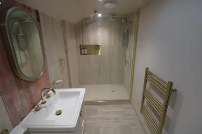a bathroom with a white sink and a shower at Drakes Rest, Kirklinton with hot tub, ideal romantic escape in Kirklinton