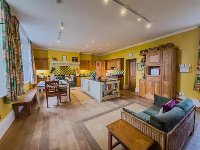 a living room with a couch and a table at Eden Mount, Wetheral, characteful, spacious home overlooking village green, close to M6 in Wetheral