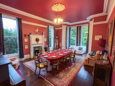 a large living room with a table and chairs at Eden Mount, Wetheral, characteful, spacious home overlooking village green, close to M6 in Wetheral