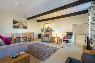 a living room with a couch and a table at Ben Place Cottage - Grasmere in Grasmere