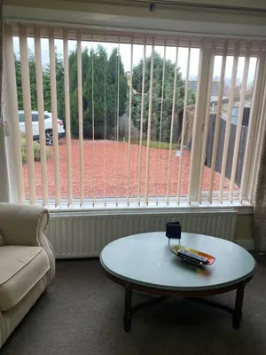 a living room with a coffee table and a large window at Gramhor House in Dumfries