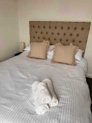 a bed with two towels on top of it at Modern 3 Bedroom Home in Egremont, Western Lake District, Sleeps up to 6 in Egremont