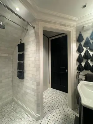 a bathroom with a black door and a sink at West London Boutique Apartment in Moffat