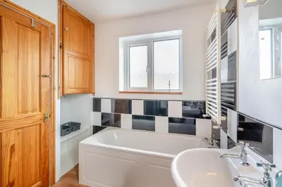 a bathroom with a tub and a sink at 3 Bed in Portinscale oc-w31059 in Portinscale