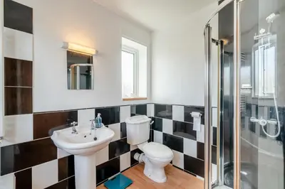 a bathroom with a toilet and a sink and a shower at 3 Bed in Portinscale oc-w31059 in Portinscale