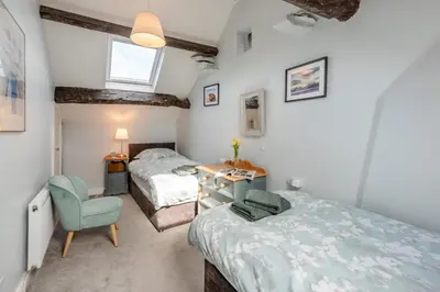 a twin bedroom with two beds and a chair at 2 Bed in Dean oc-h32066 in Dean