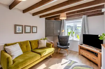a living room with a green couch and a television at 2 Bed in Dean oc-h32066 in Dean
