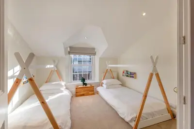 two beds in a room with white walls at 5 Bed in Keswick oc-h33619 in Keswick