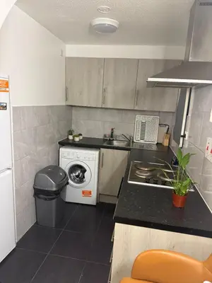a kitchen with a washing machine and a sink at House of Card in Moffat