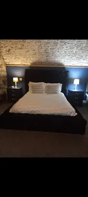 a bedroom with a bed with two lights on it at Town Centre Apartment in Gatehouse of Fleet