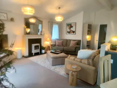 a living room with a couch and a fireplace at 10 lochview in Moffat