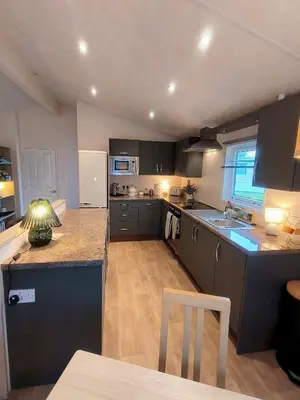 a kitchen with gray cabinets and a counter top at 10 lochview in Moffat