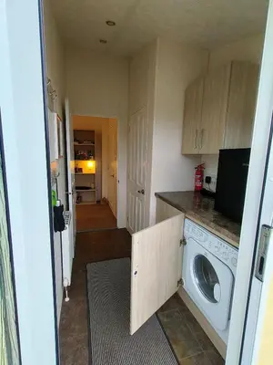 a kitchen with a washing machine in a room at 10 lochview in Moffat