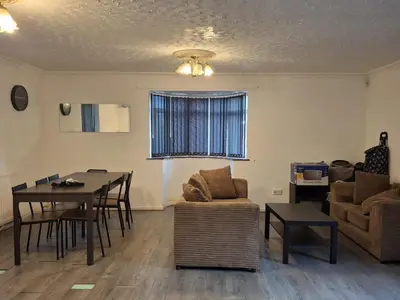 a living room with a couch and a table at Akwaaba services in Moffat