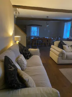 a living room with a couch and a dining room at Highside farm in Embleton