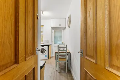 a hallway with a table and a kitchen with a washing machine at Vintage 2 Bed House in Lamplugh in Lamplugh