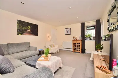 a living room with a couch and a table at Peaceful Village Flat 2 Bedrooms in Douglas