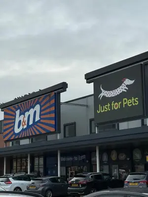 a store with cars parked in a parking lot at Pearl House in Moffat