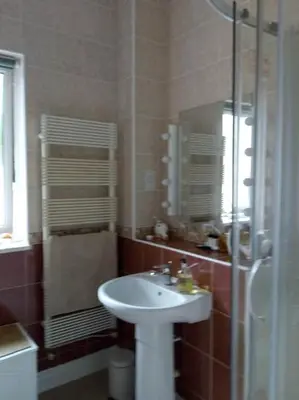 a bathroom with a sink and a glass shower at Sevenacres Kelso in Moffat