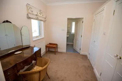a bathroom with a vanity and a mirror and a sink at Sevenacres Kelso in Moffat