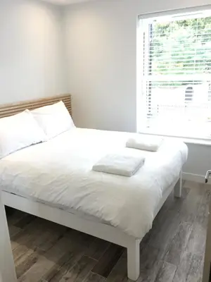 a white bed in a room with a window at The Palms in Moffat