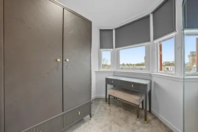 a dressing room with a desk and windows at The Penthouse - Beachwalk Apartments in Ayr