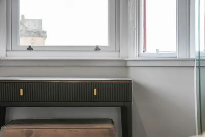 a fireplace in a room with two windows at The Penthouse - Beachwalk Apartments in Ayr