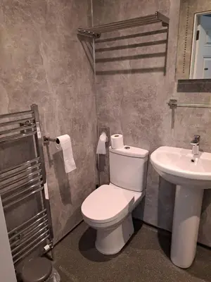 a bathroom with a toilet and a sink at Brewery house in Newton Stewart