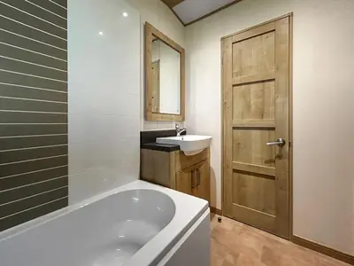 a bathroom with a bath tub and a sink at Millars Caravan in Ayr