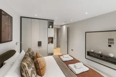 a bedroom with a white couch and a television at Bright 3BR London Flat w Full Kitchen in Moffat