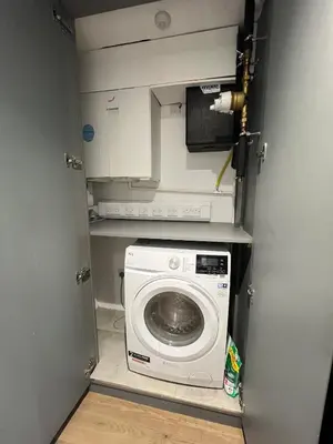 a laundry room with a washing machine in it at Modern City Apartment, Fast Wi-Fi, Great View in Moffat