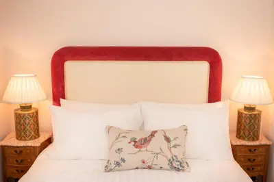 a bedroom with a bed with two lamps on tables at Springkell in Eaglesfield