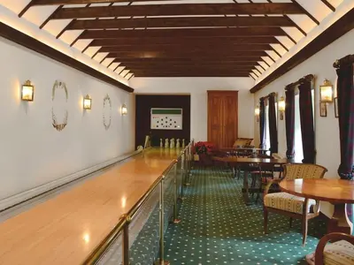 a dining room with tables and chairs and a bowling alley at Holiday Home Gehöft 4 by Interhome in Tweedsmuir
