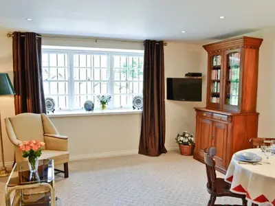 a living room with a table and a window at Holiday Home Gehöft 2 by Interhome in Tweedsmuir